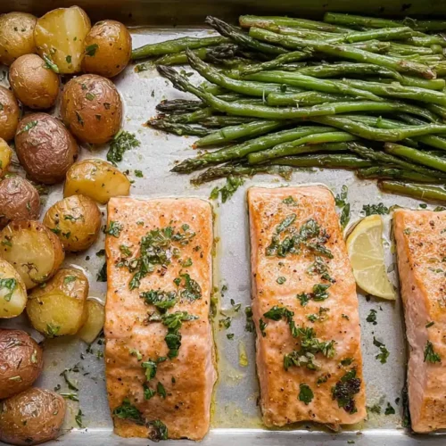 A freshly cooked one-pan salmon dinner with roasted vegetables