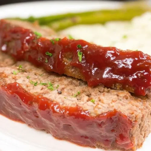 A traditional meatloaf with a rich brown sugar glaze, freshly baked and ready to serve.