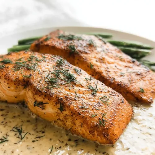 A freshly prepared weeknight baked salmon meal with vegetables and herbs