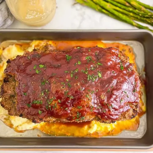 A well-baked weeknight comfort meatloaf, sliced and ready to serve.
