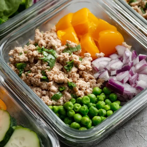 A neatly organized healthy ground turkey meal prep container with vegetables.