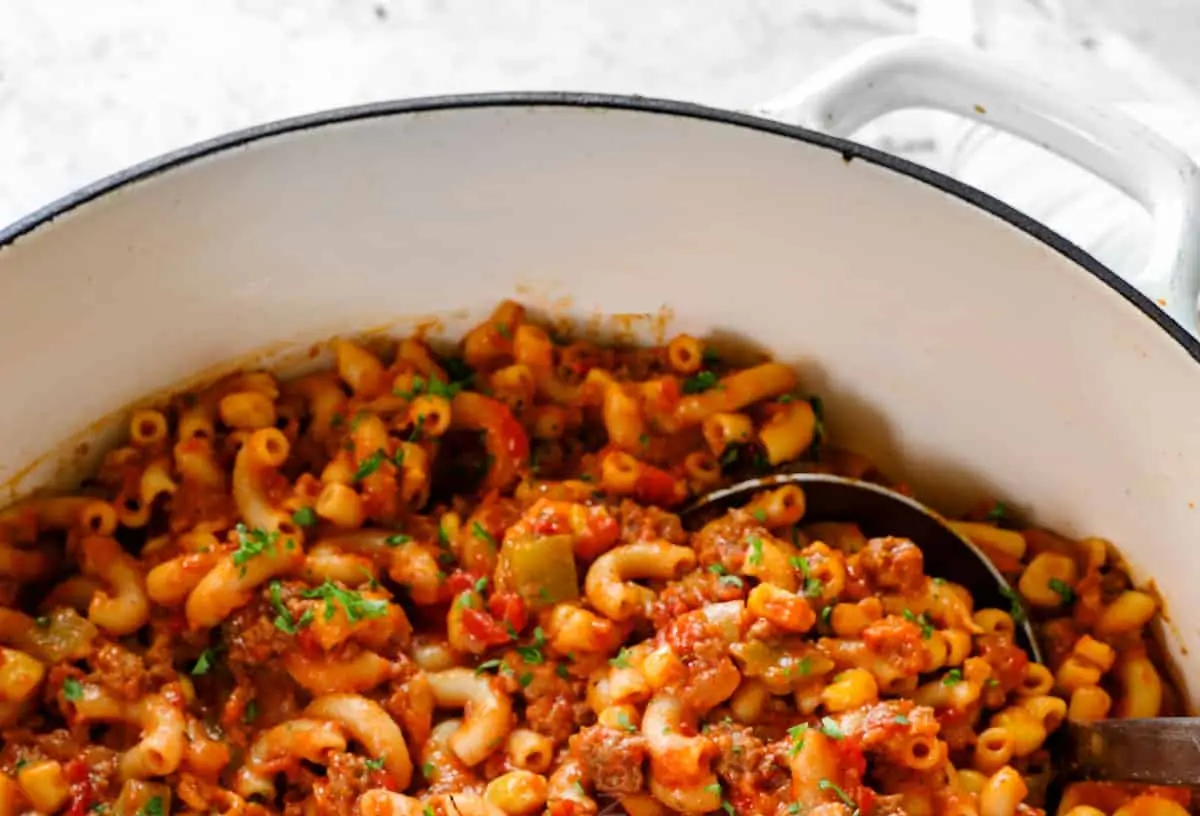 A steaming bowl of hearty American goulash with pasta and meat