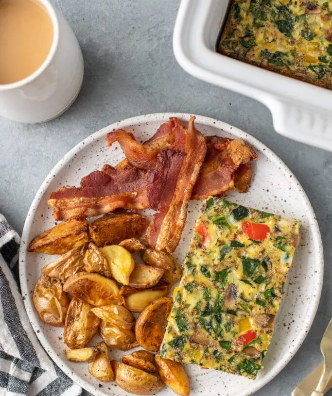 A freshly baked clean eating breakfast casserole in a baking dish, ready to serve.