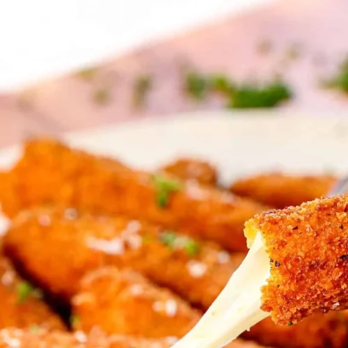 A plate of golden-brown mozzarella sticks, perfectly fried and ready to be served.
