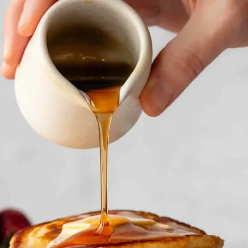 Stack of fluffy buttermilk pancakes with syrup and butter