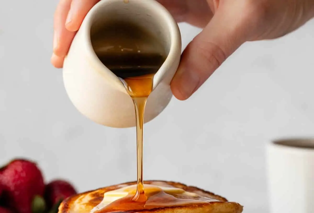 Stack of fluffy buttermilk pancakes with syrup and butter
