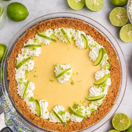 A vibrant green key lime pie with whipped cream topping