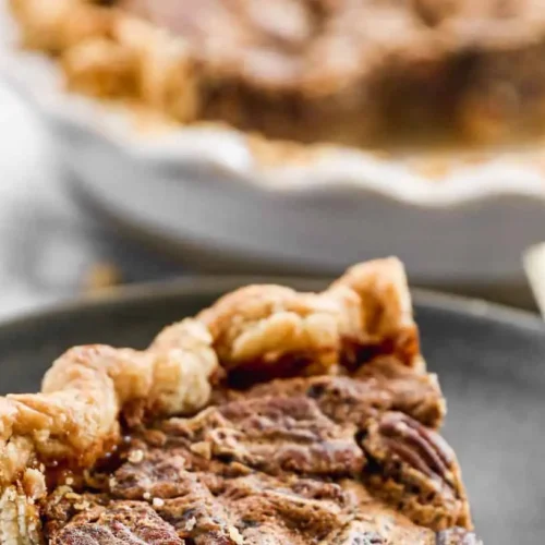 A freshly baked whole pecan pie with a golden crust