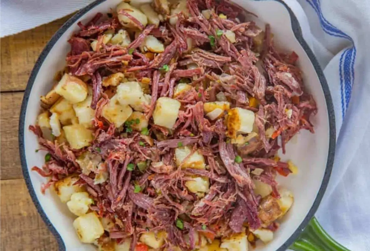 A serving of savory corned beef hash, freshly cooked and steaming