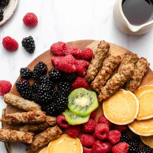 A table set with simple family breakfast items like toast, fruit, and eggs.