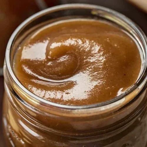 Cooked apples simmering in a slow cooker, transforming into slow cooker apple butter