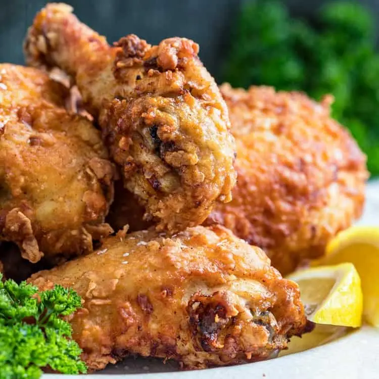 A fresh batch of crispy Southern fried chicken, perfectly golden brown on a platter.