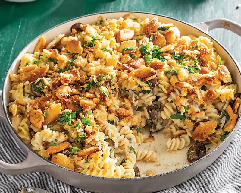 A steaming hot tuna noodle casserole in a baking dish, fresh from the oven.