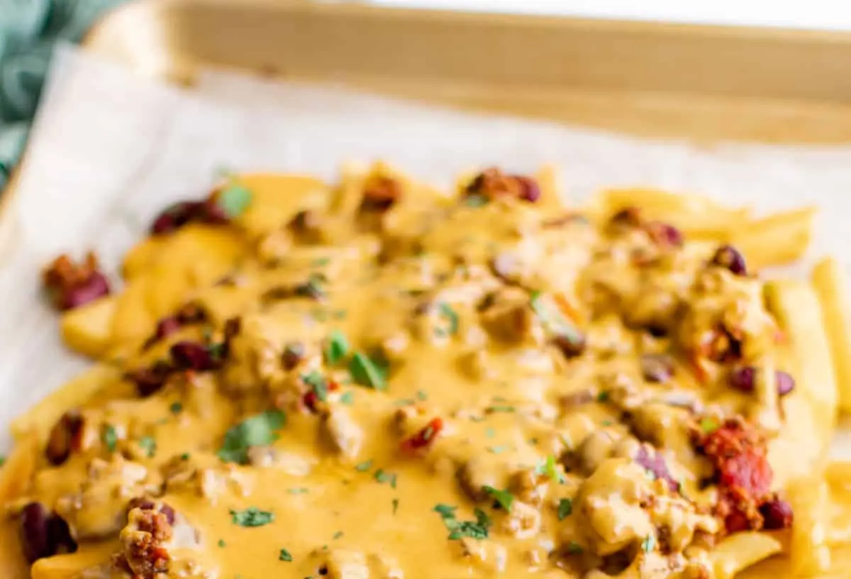 A generous serving of crispy french fries generously topped with savory chili and melted cheese
