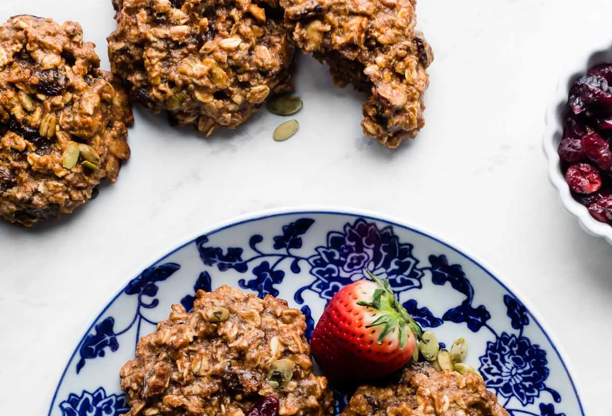 A variety of wholesome breakfast ideas laid out on a table, including fruit, oats, and eggs.